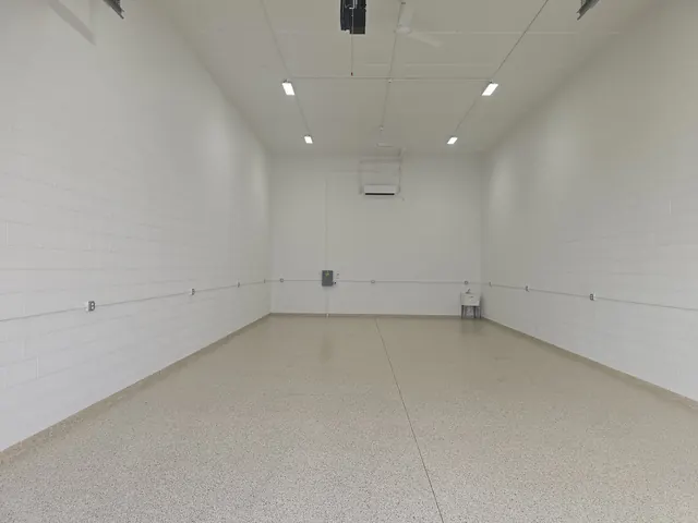 Finished garage condo interior with speckled epoxy floor