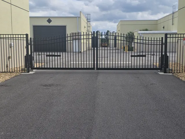 Gated entrance to the garage condo property with wide paved drive